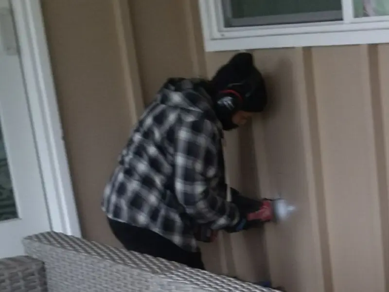 Professional electrician installing an exterior outlet in Laurel
